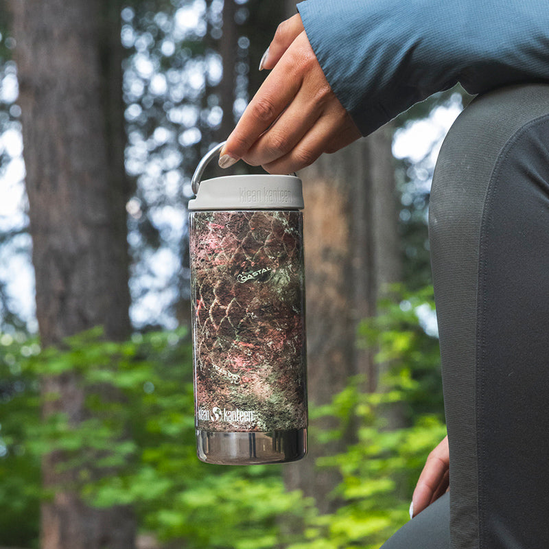 12oz-tkwide-with-twist-cap-mossy-oak-d6 12oz_tumbler_mossyoak_rainbowtrout_hand_closeup_square.jpg