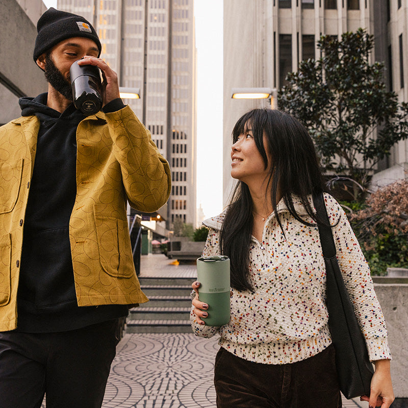 16oz-rise-tumbler-v2 16oz_rise_tumbler_black_iceberg_couple_drink_city_street_square.jpg
