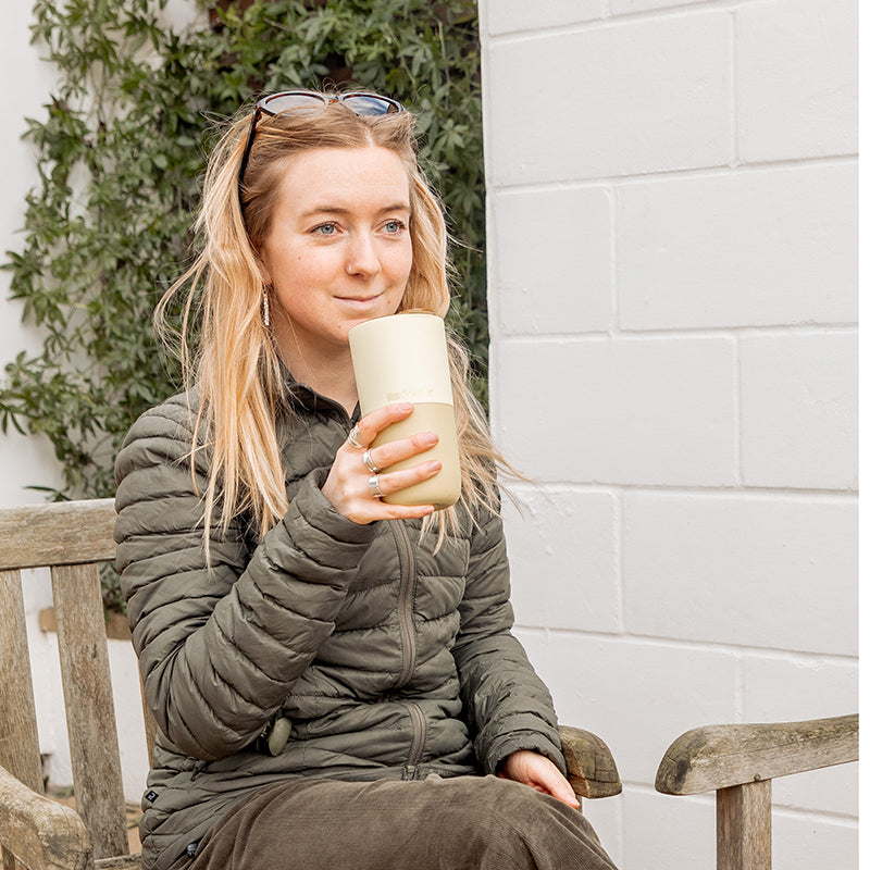 16oz-rise-tumbler-v2 16oz_rise_tumbler_wax_yellow_woman_seat_outside_square.jpg