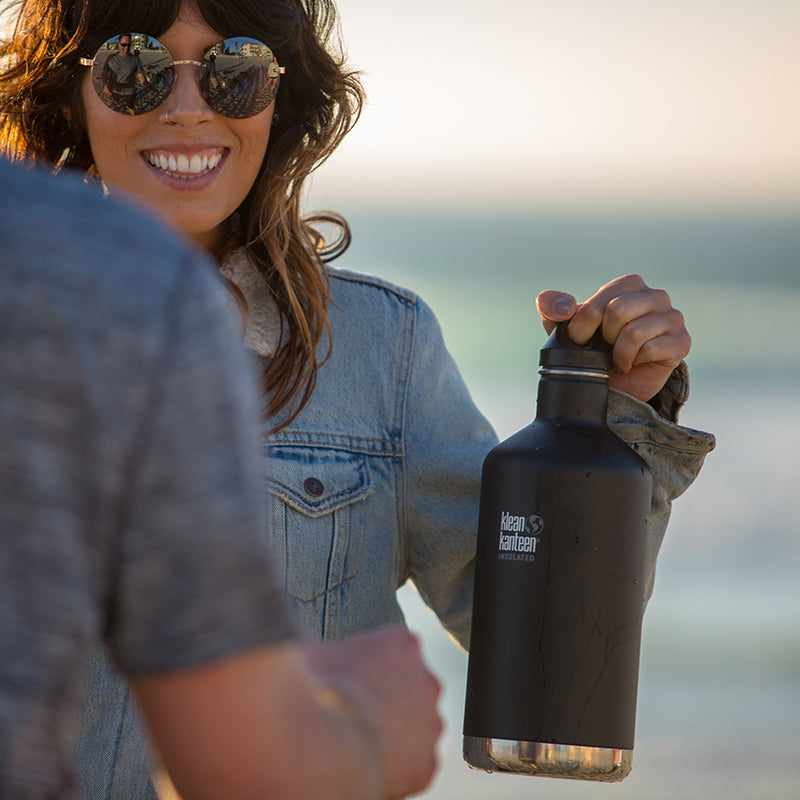 64oz-classic-with-loop-cap-i7 64oz_insulated_classic_black_beach_girl_hand_square.jpg