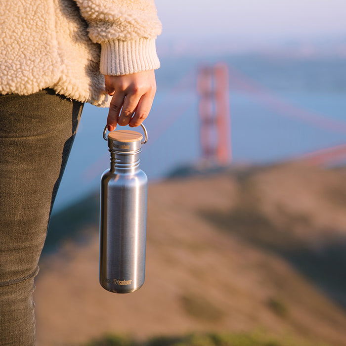 27oz-reflect-with-bamboo-cap-g5 K27SSLRF-BS-BAMBOO_reflect_bottle_bridge_lifestyle.jpg